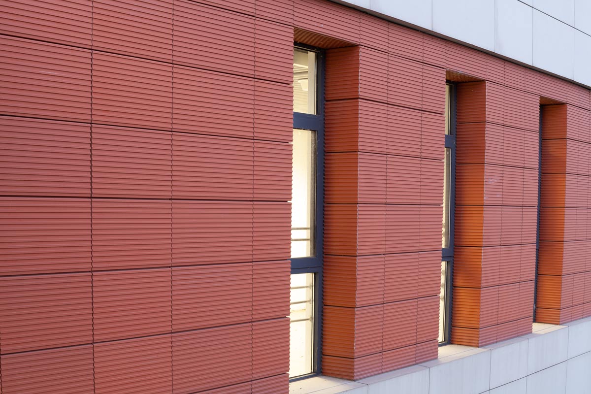 Red grooved terracotta panel of metro station.jpg