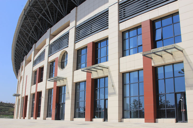 Creamy white terracotta rainscreen facade for stadium project.jpg