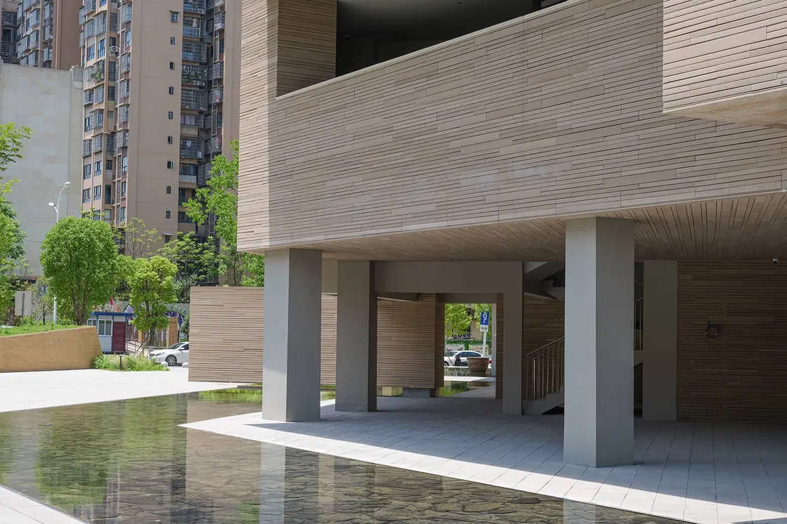 The exterior water feature integrates with the building's terracotta facade.jpg