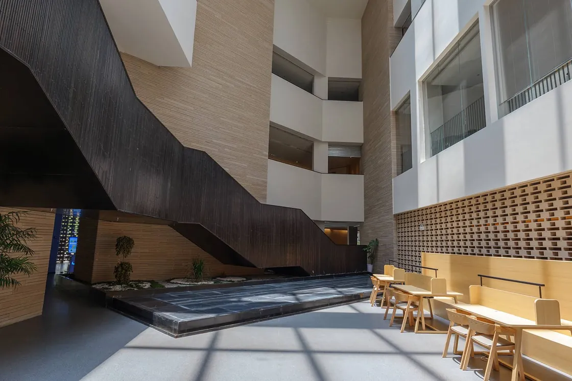 The interior terracotta facade design creates a warm, textured atmosphere in the lobby.jpg