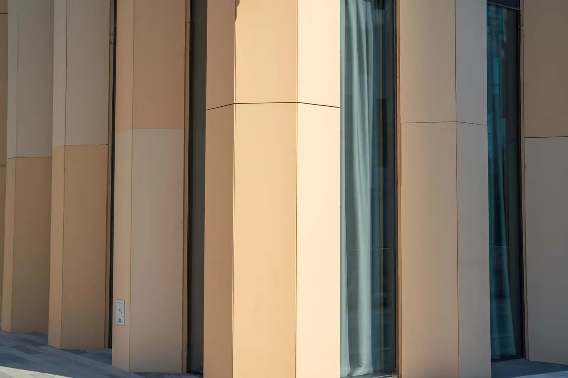 Close-up of LOPO terracotta panels at HaiKai Park showing the overlap edge and textured champagne surface..jpg