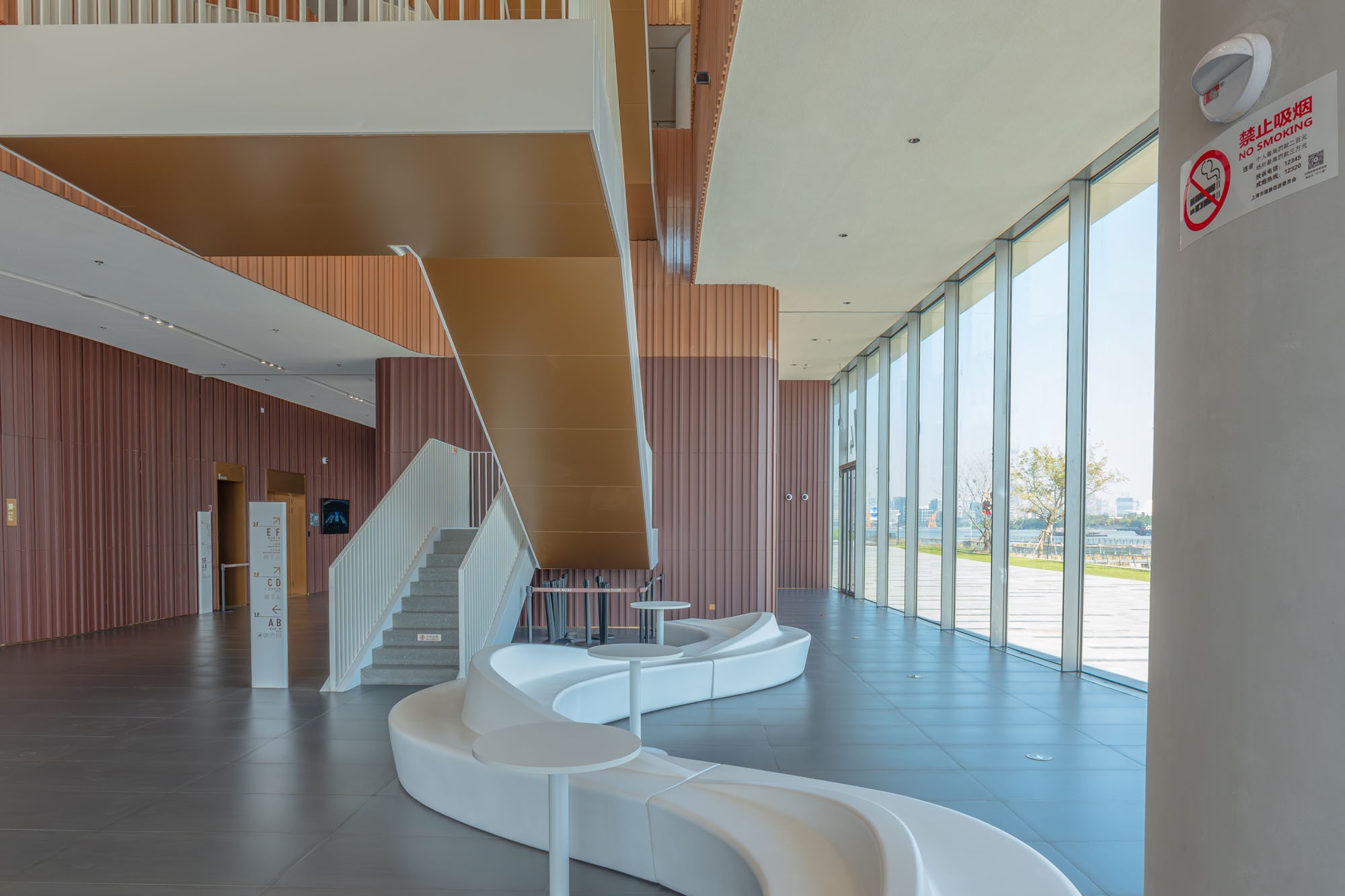 Dark brown and ochre terracotta walls beside a lobby waiting area.