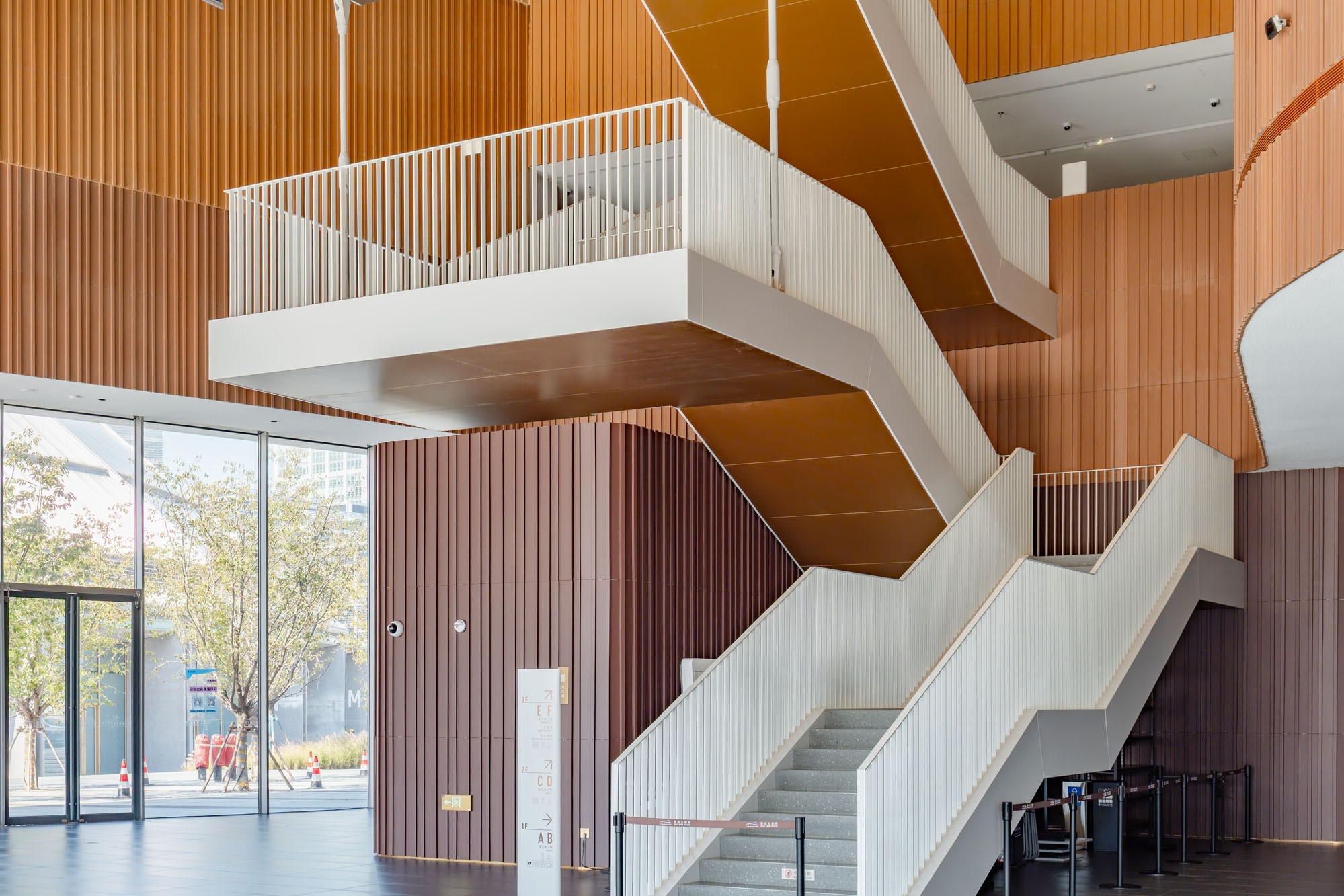 Terracotta cladding in the lobby stair and elevator area.