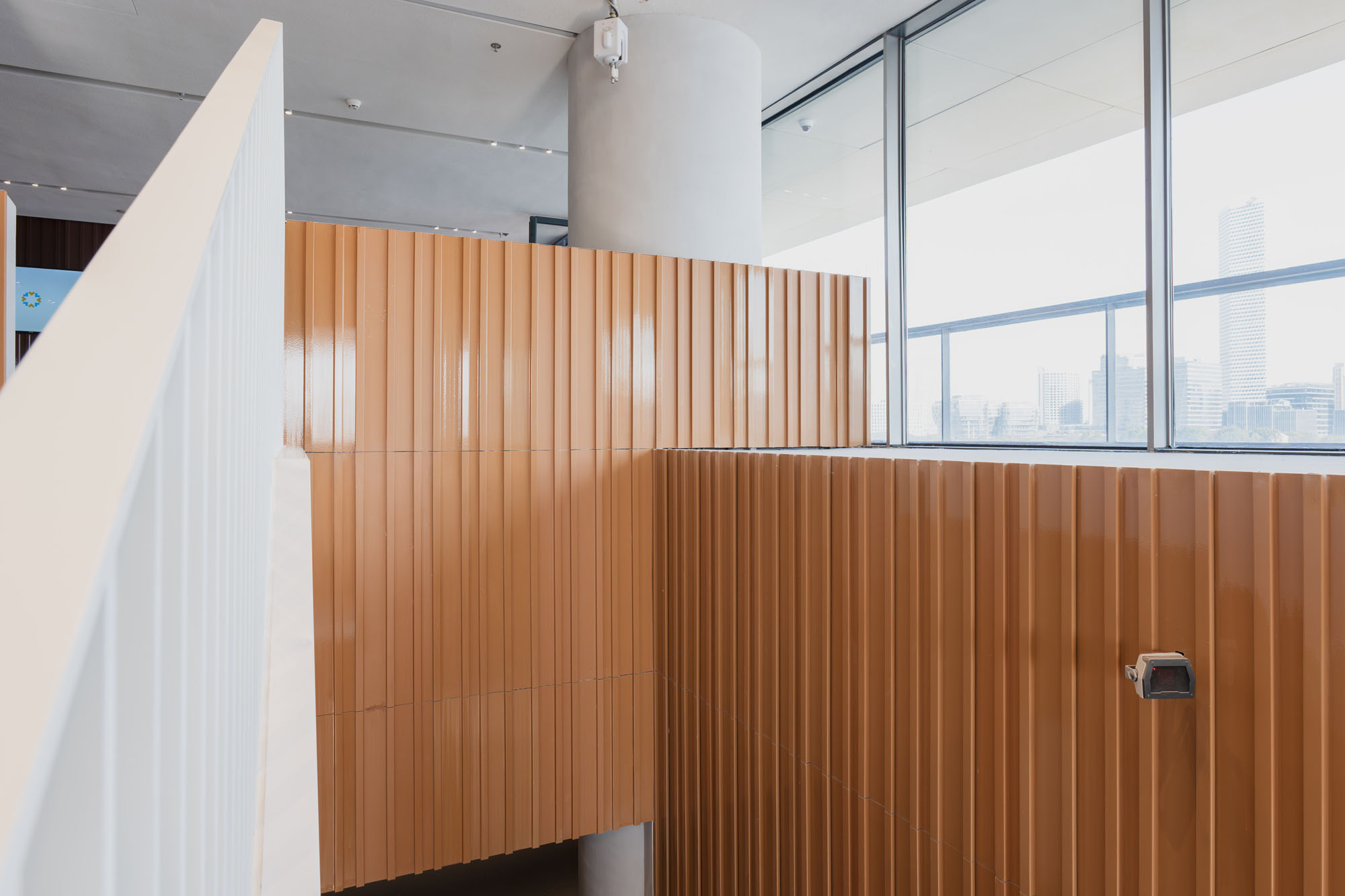 Matte and low-sheen glaze finishes on profiled terracotta panels.