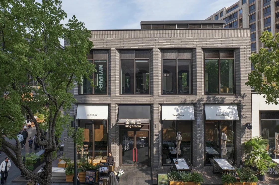 Front elevation of a gray clay facing brick retail facade at Yiwu Place