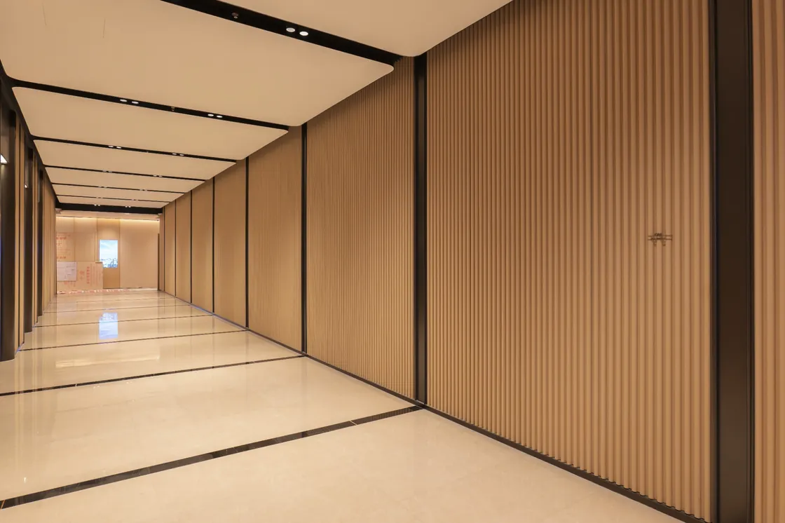 Oblique view of an EIC corridor with tall ribbed wall cladding and a linear ceiling.